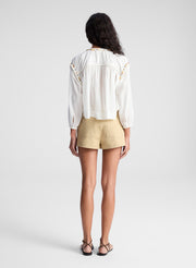 woman wearing white blouse and beige lace up detail short