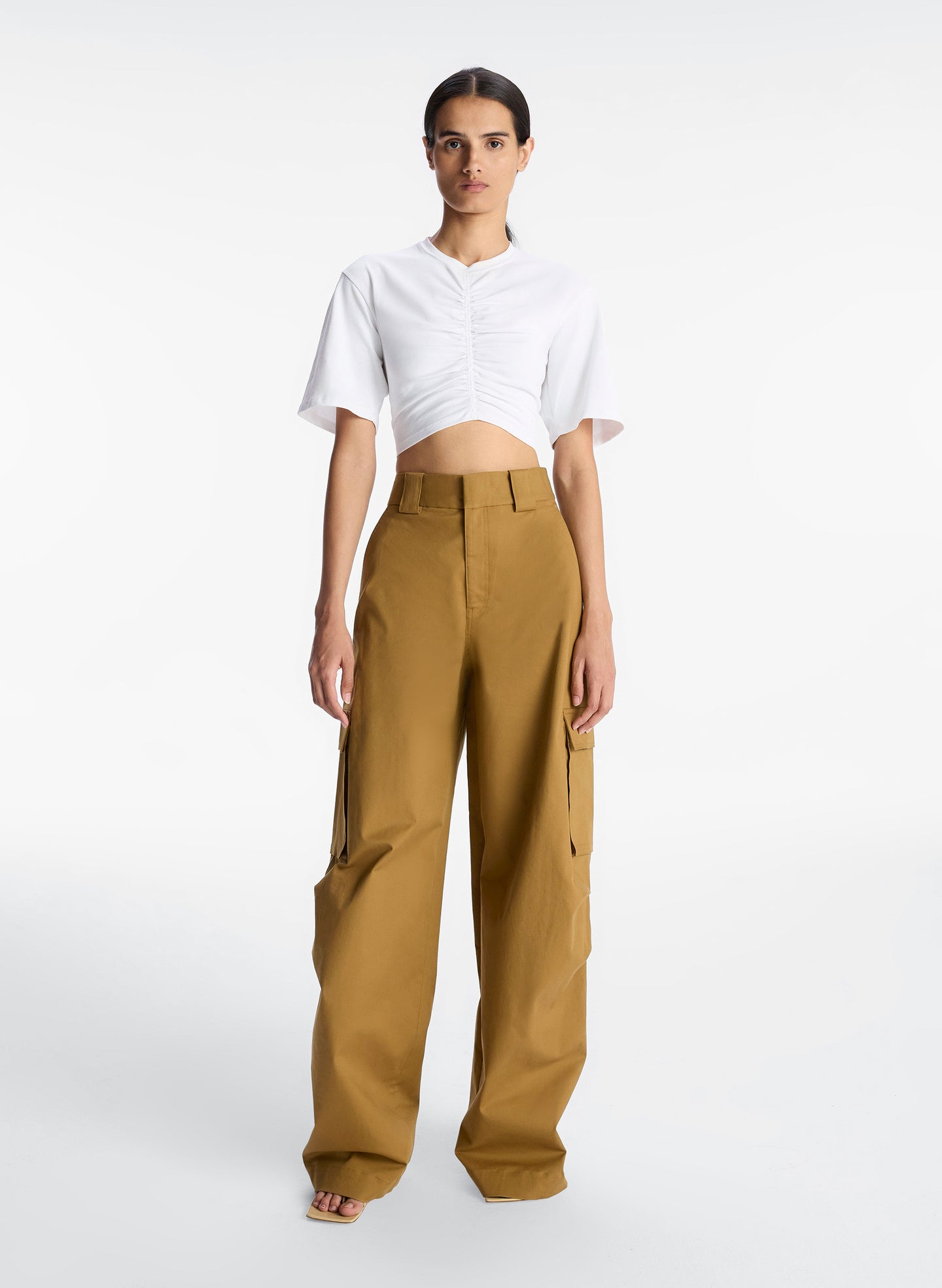 front view of woman wearing white tshirt with center ruching and tan cargo pants