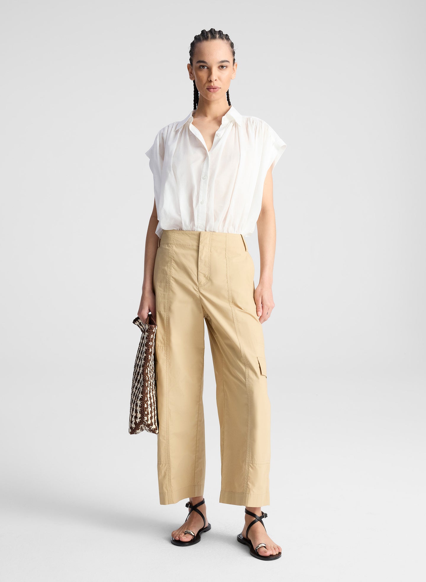 woman wearing white shirt and beige pants