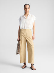 woman wearing white shirt and beige pants