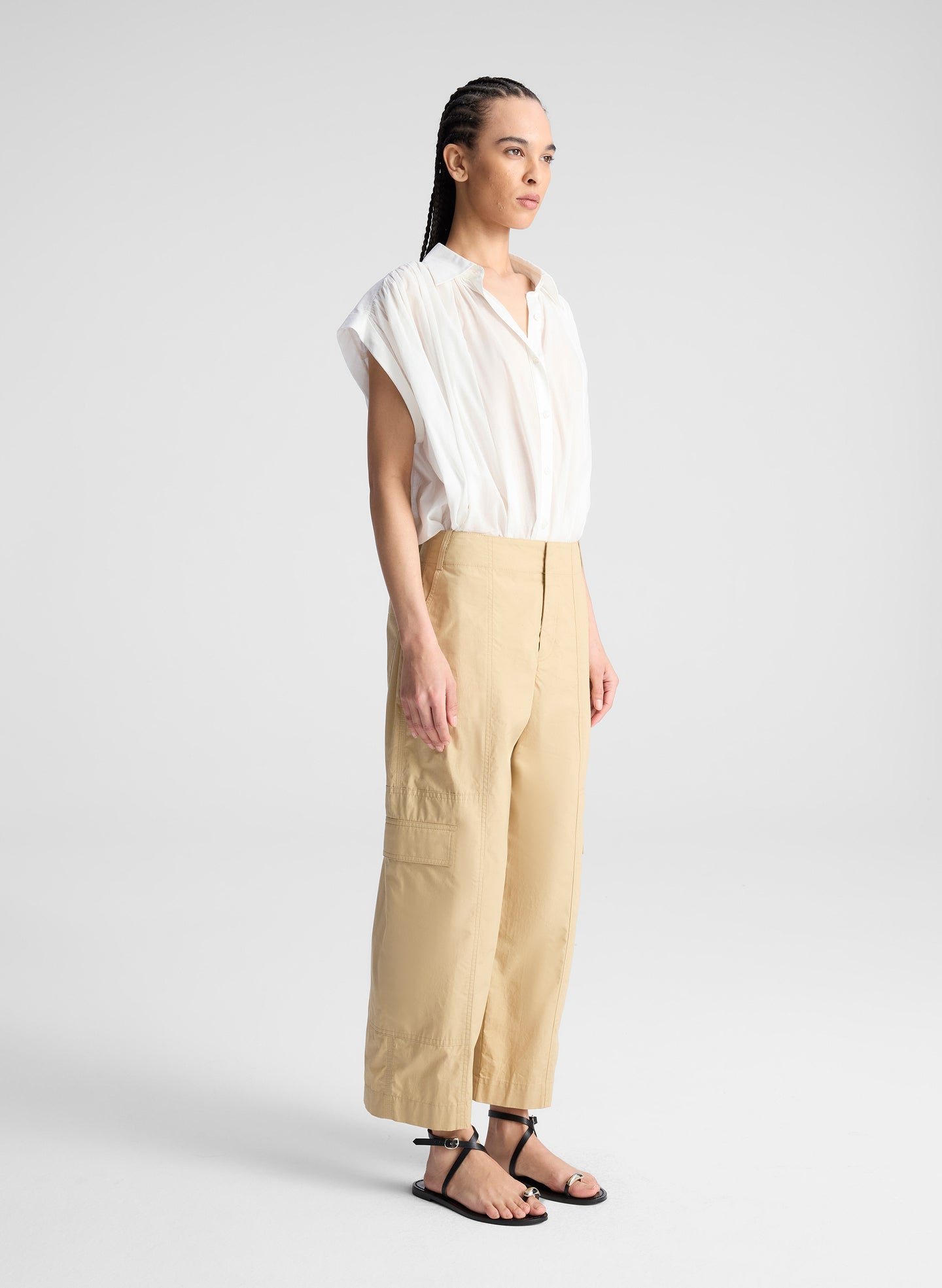 woman wearing white shirt and beige pants
