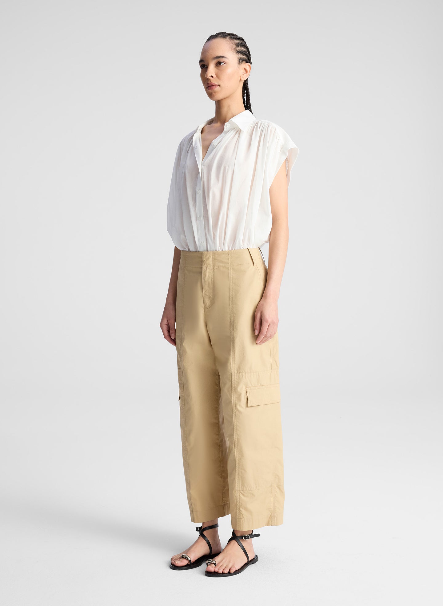 woman wearing white shirt and beige pants