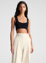 woman wearing black bra top and beige pants