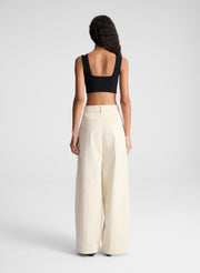 woman wearing black bra top and beige pants