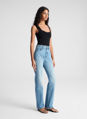 woman wearing black tank top and blue denim