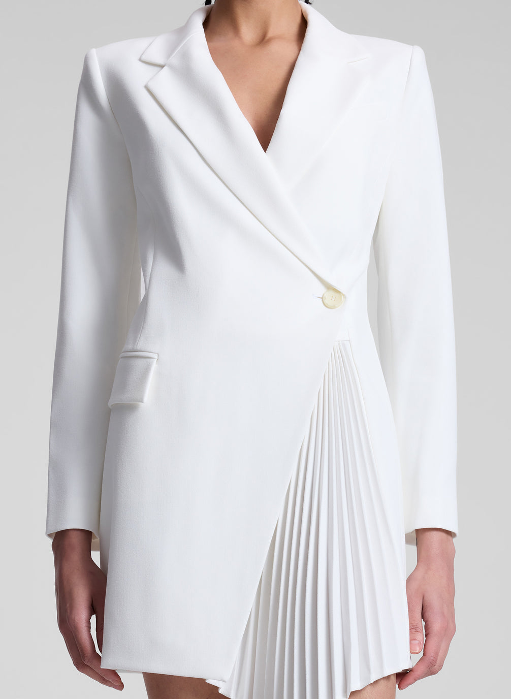 woman wearing white pleated blazer dress