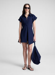 woman wearing navy blue mini shirt dress