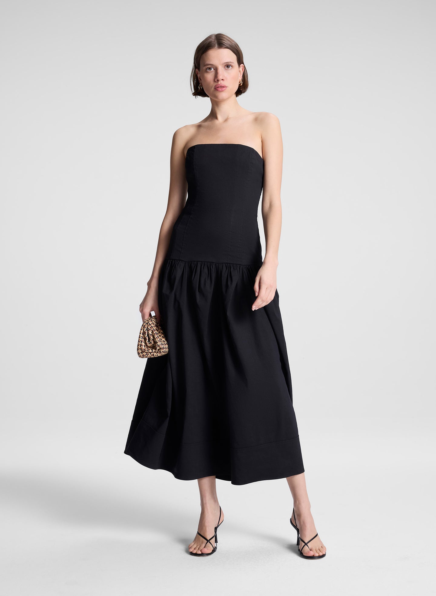 woman wearing black strapless drop waist midi dress