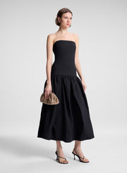 woman wearing black strapless drop waist midi dress