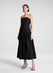 woman wearing black strapless drop waist midi dress