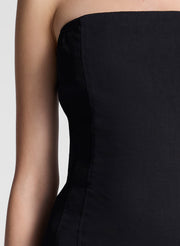 woman wearing black strapless drop waist midi dress