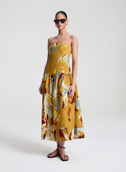 woman wearing yellow printed strapless midi dress