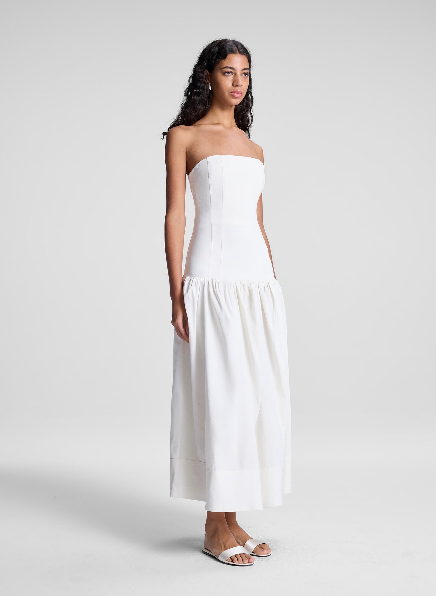woman wearing white strapless drop waist midi dress