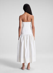 woman wearing white strapless drop waist midi dress