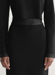 woman wearing black top and black skirt