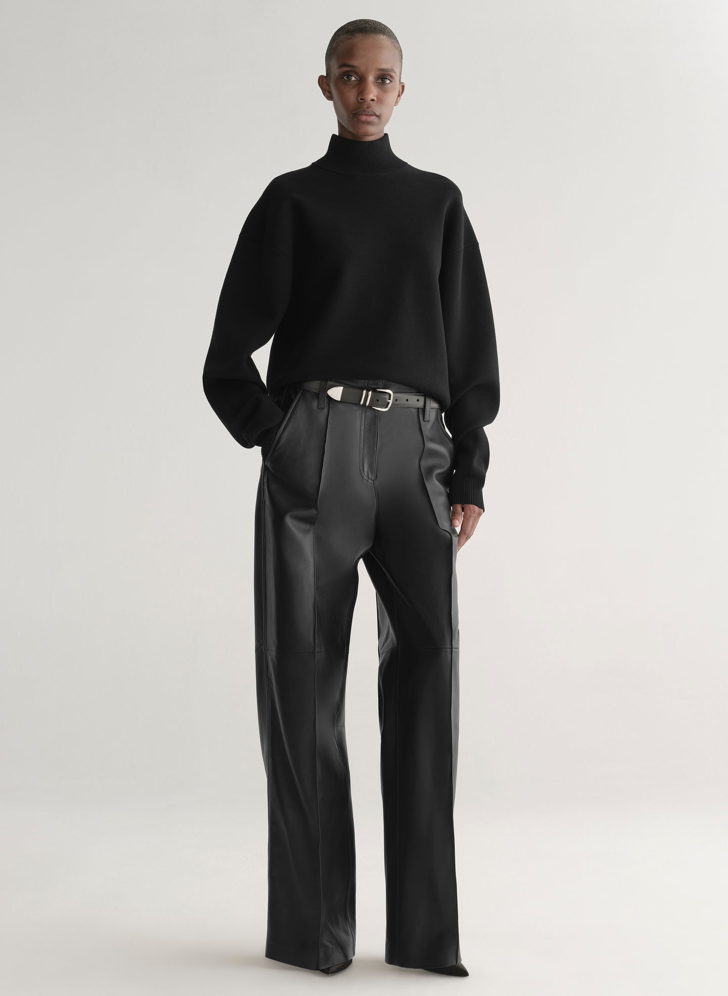 woman wearing black turtleneck sweater and black leather pants