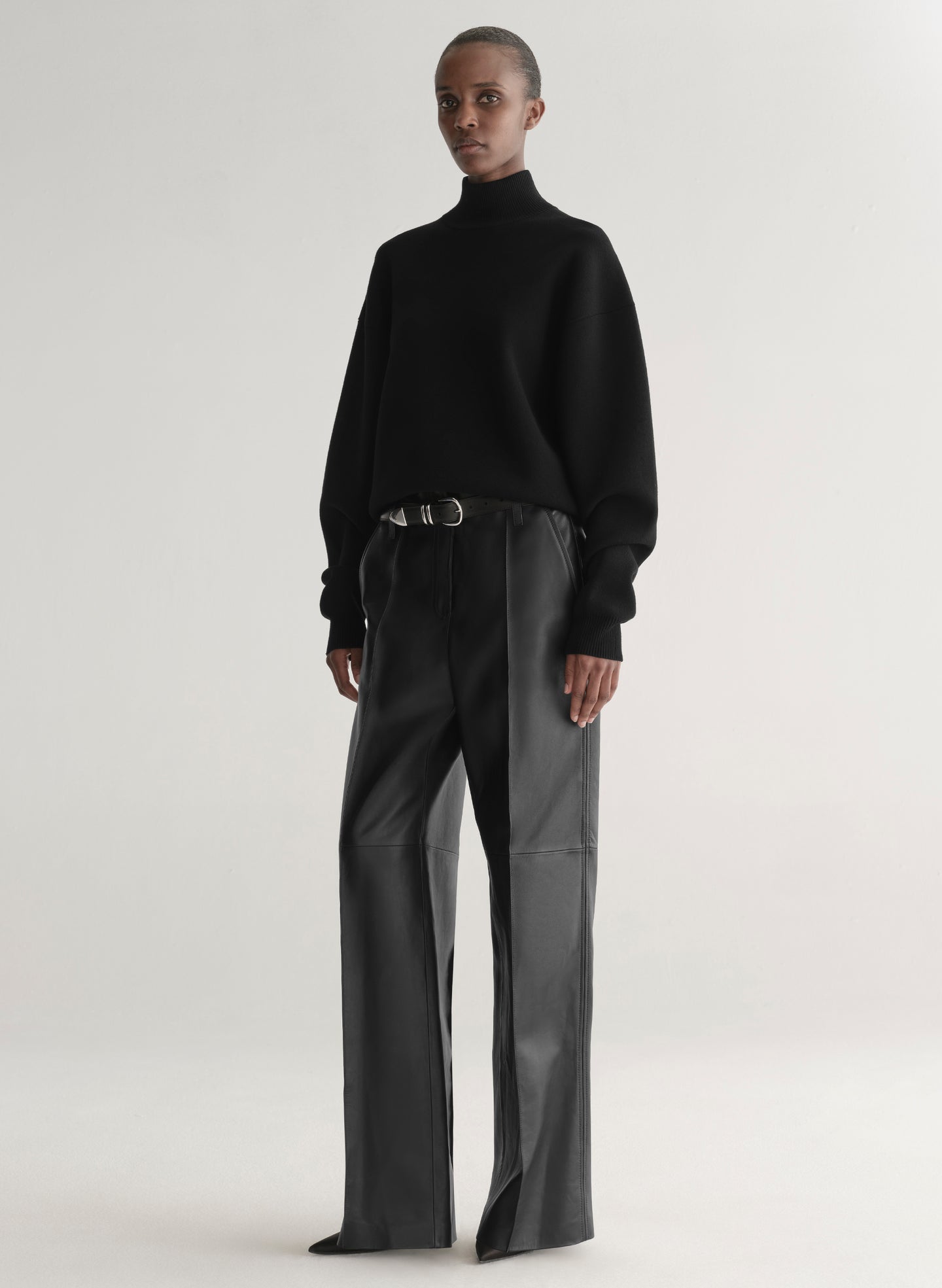 woman wearing black turtleneck sweater and black leather pants