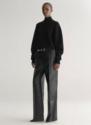 woman wearing black turtleneck sweater and black leather pants