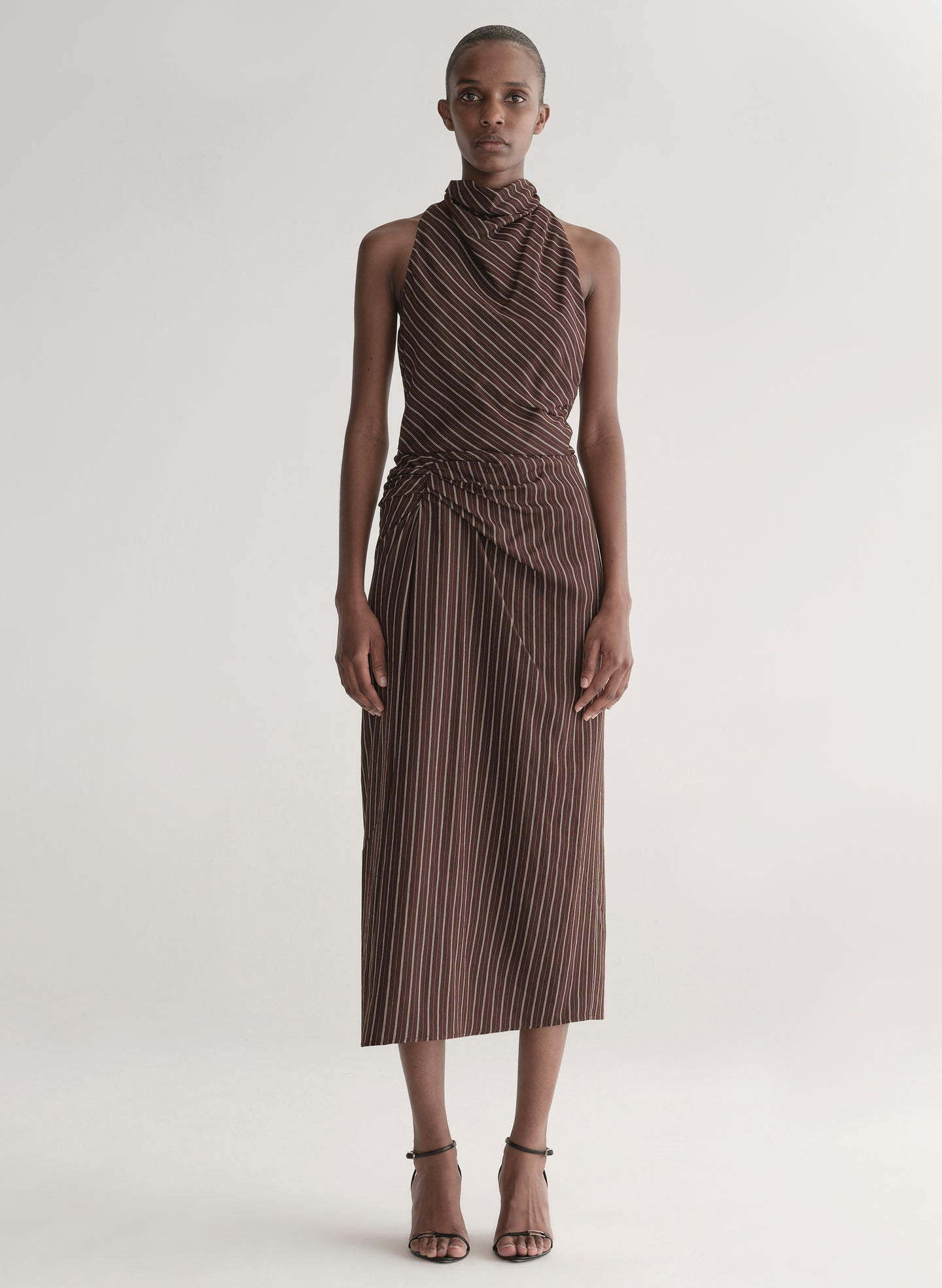 woman wearing brown striped top and matching midi skirt