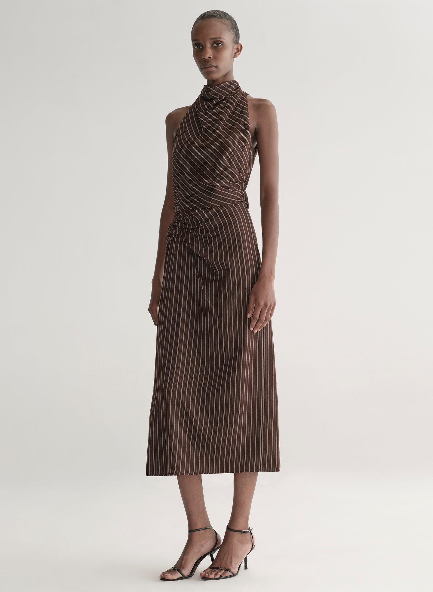 woman wearing brown striped top and matching midi skirt