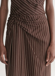 woman wearing brown striped top and matching midi skirt