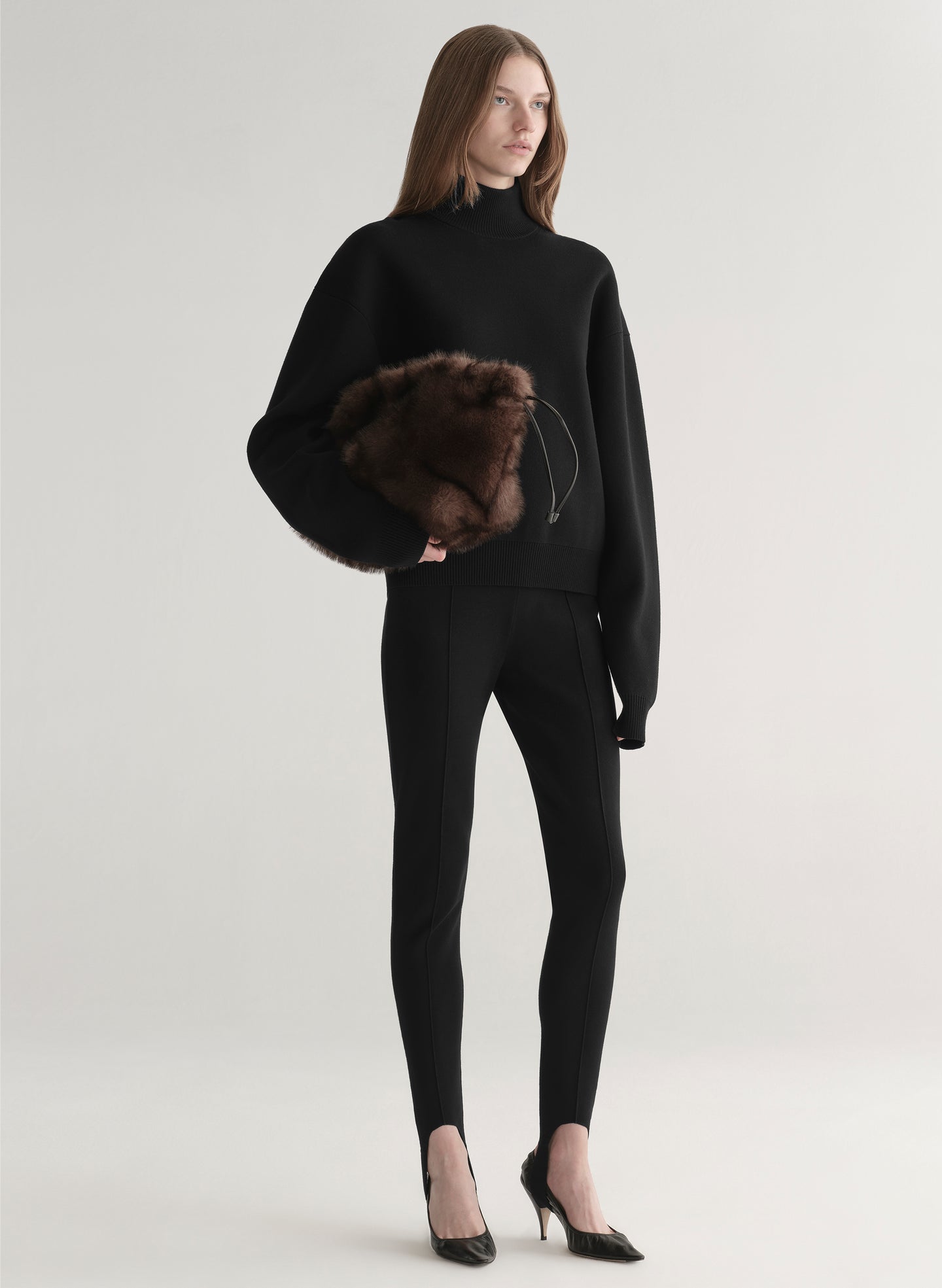 woman wearing black turtleneck sweater and black stirrup pants