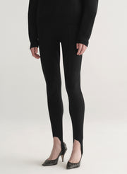 woman wearing black turtleneck sweater and black stirrup pants