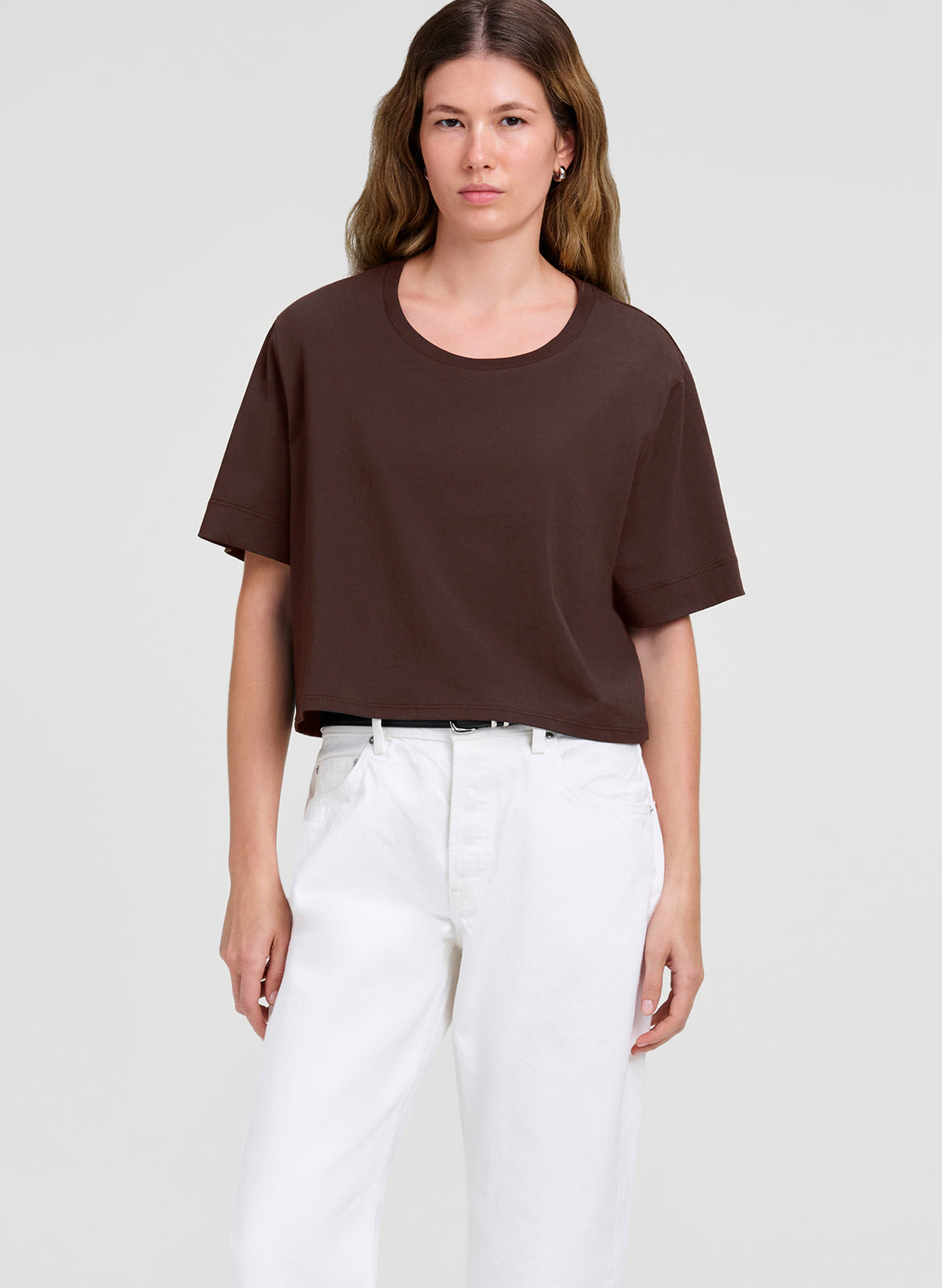 woman wearing brown crop tee and white jeans