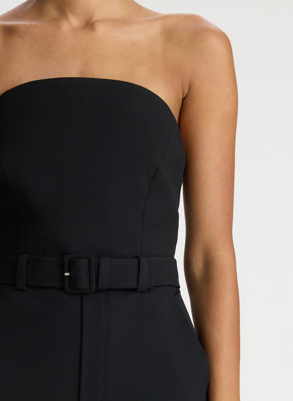 detail view of woman wearing black strapless jumpsuit