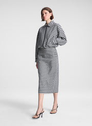 woman wearing black and white plaid gingham jacket and matching skirt