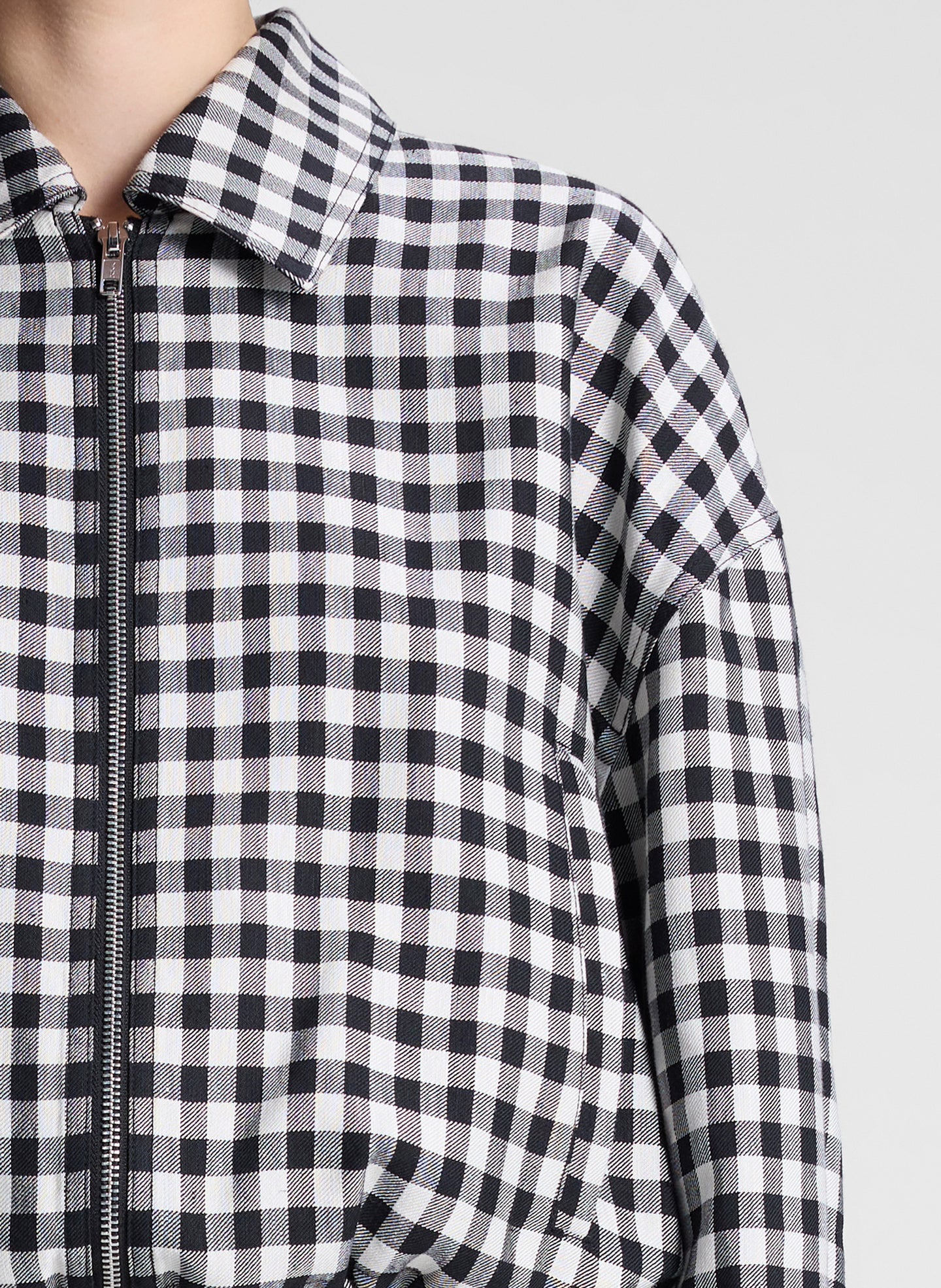 woman wearing black and white plaid gingham jacket and matching skirt