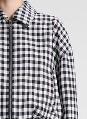 woman wearing black and white plaid gingham jacket and matching skirt