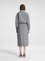 woman wearing black and white plaid gingham jacket and matching skirt