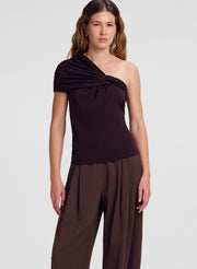 woman wearing brown one shoulder merino top and brown pants