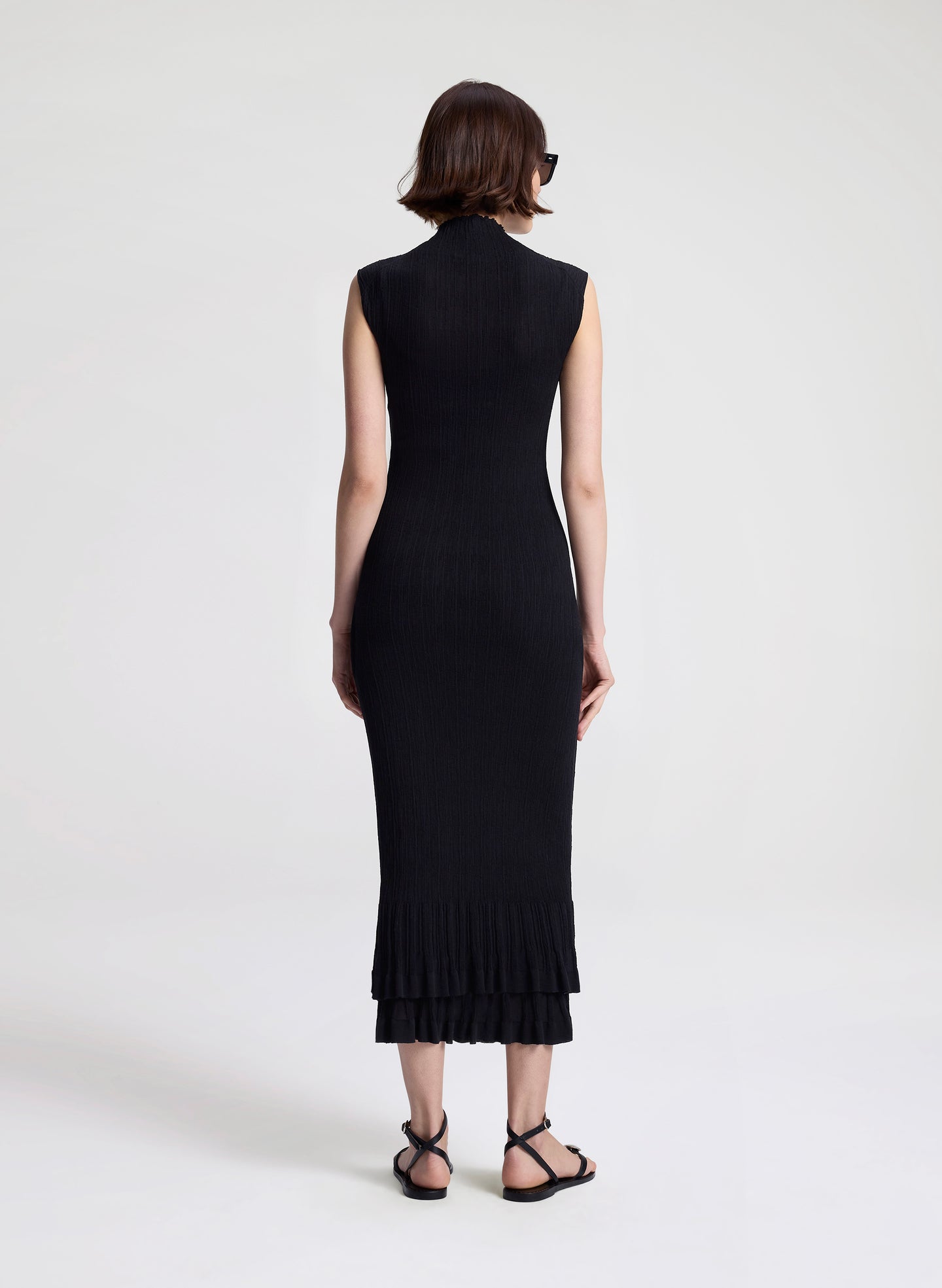 woman wearing black fine gauge voile knit midi dress