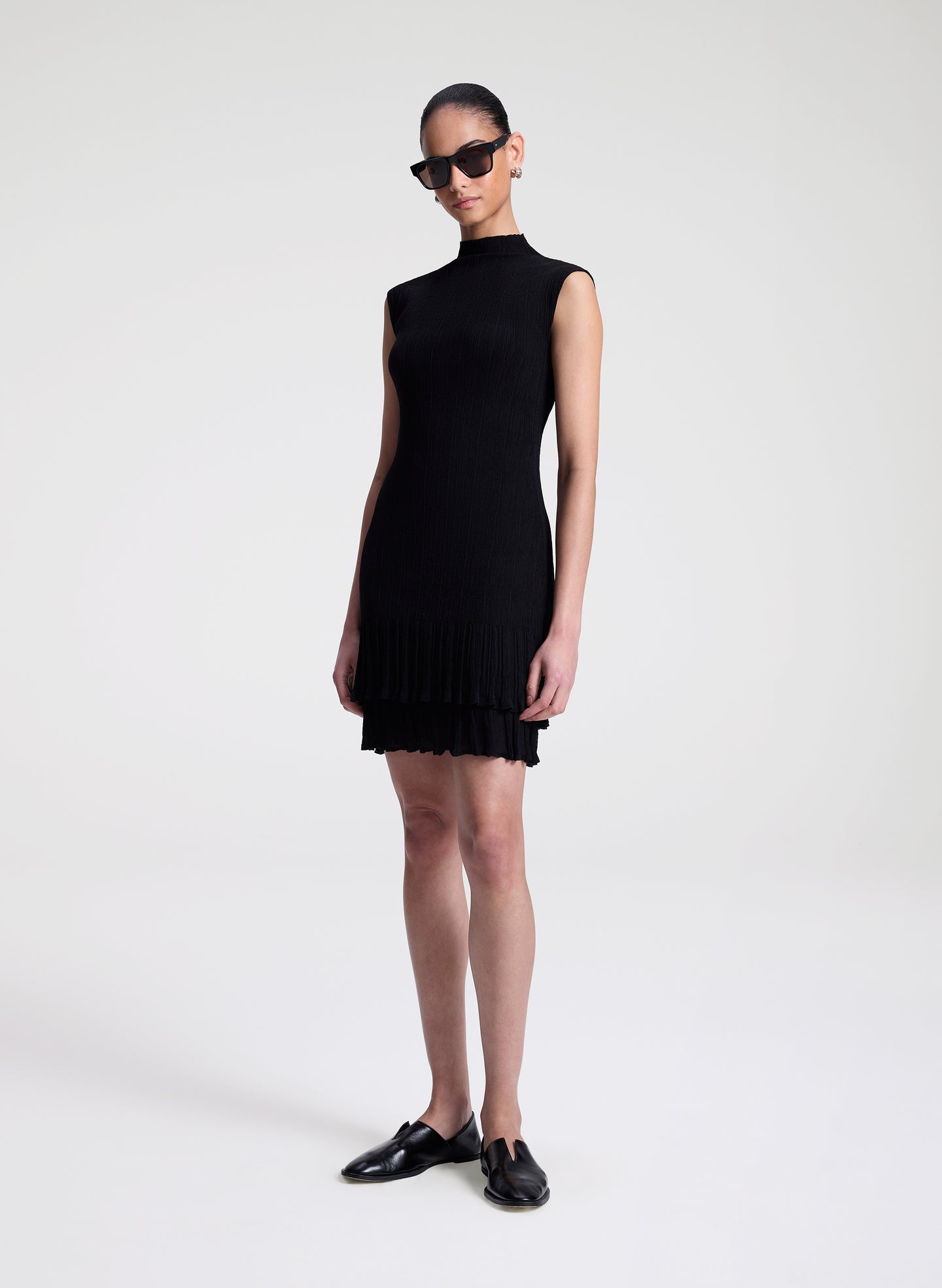 woman wearing black fine gauge voile knit mini dress