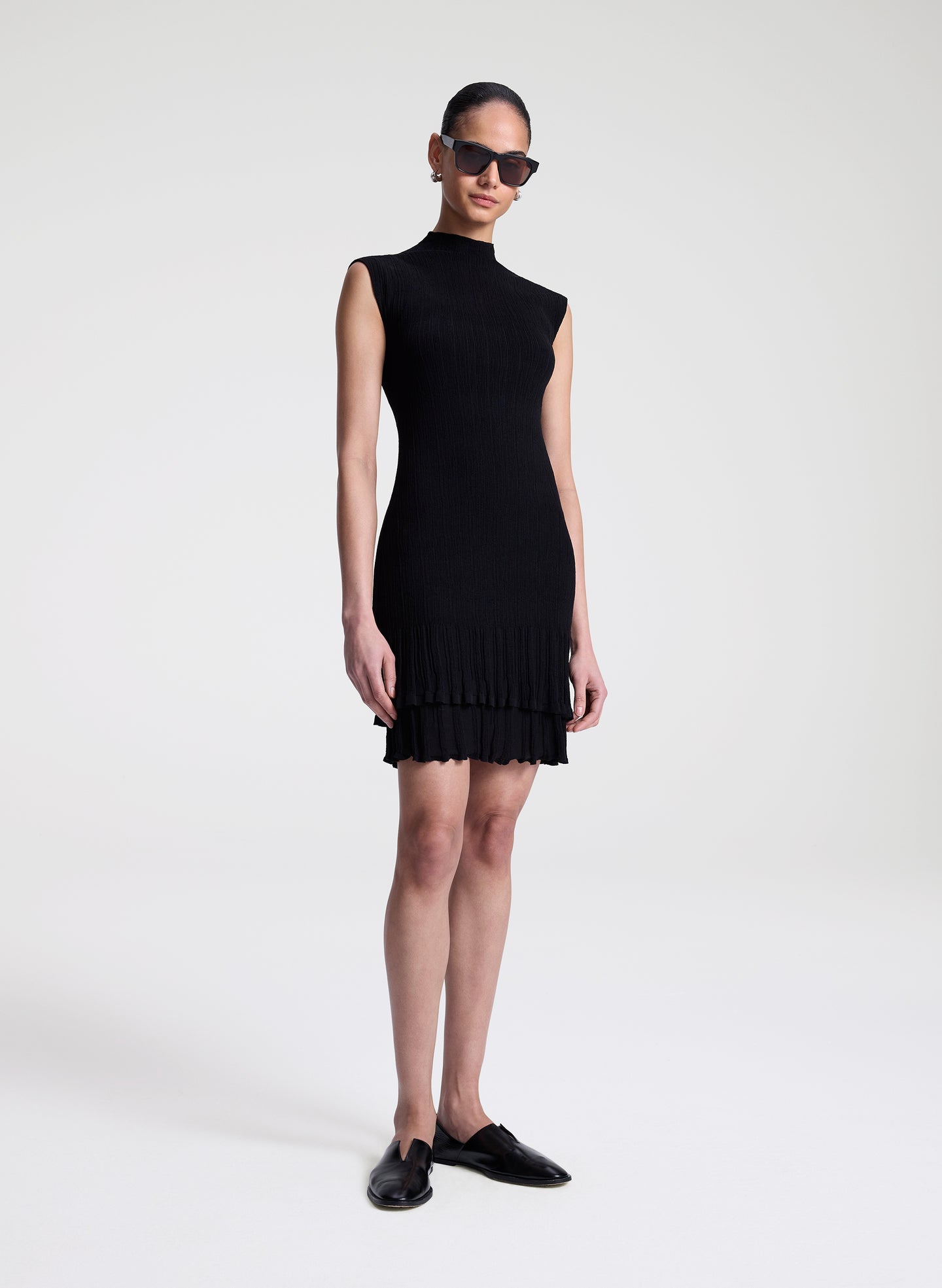 woman wearing black fine gauge voile knit mini dress