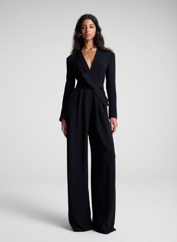 woman wearing black long sleeve jumpsuit