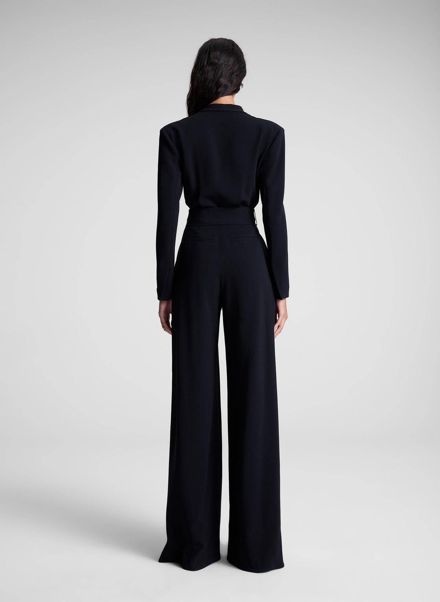 woman wearing black long sleeve jumpsuit