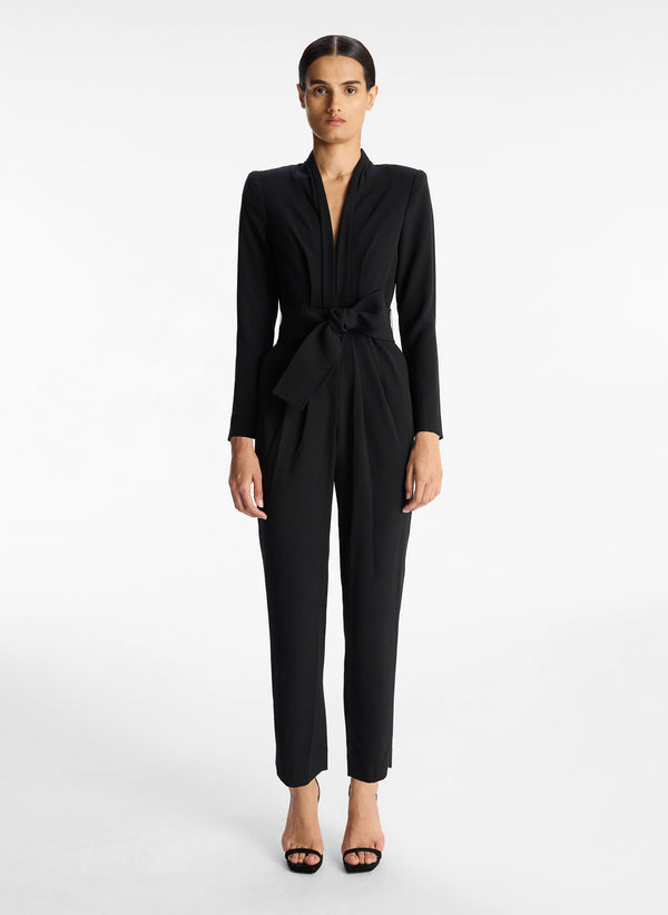 front view of woman wearing black crepe long sleeve jumpsuit