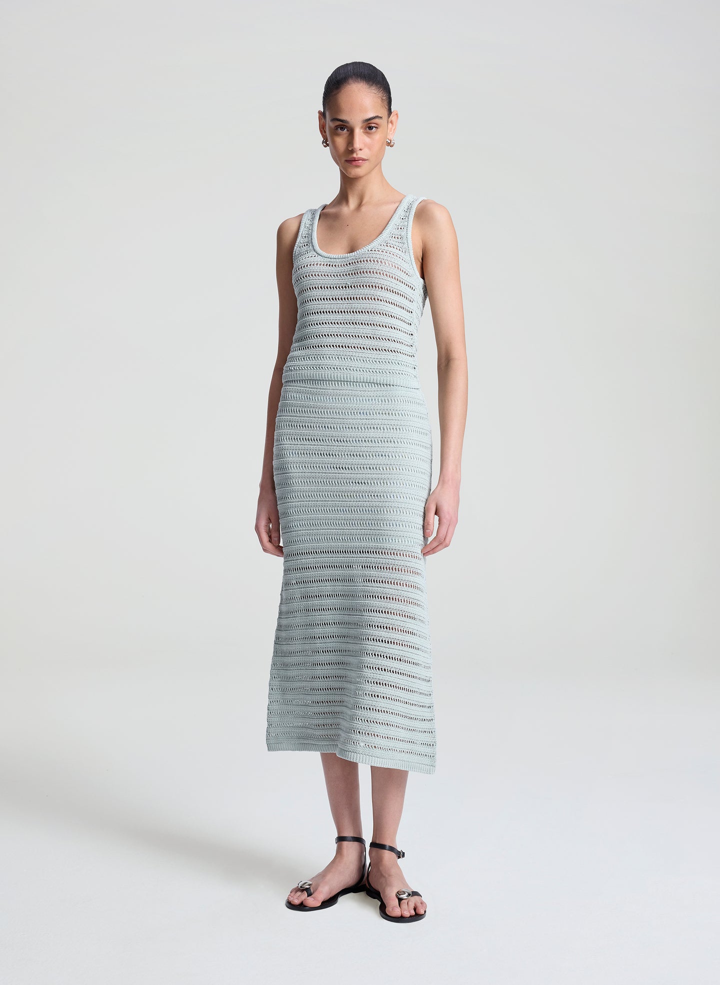 woman wearing light blue crochet tank and skirt set