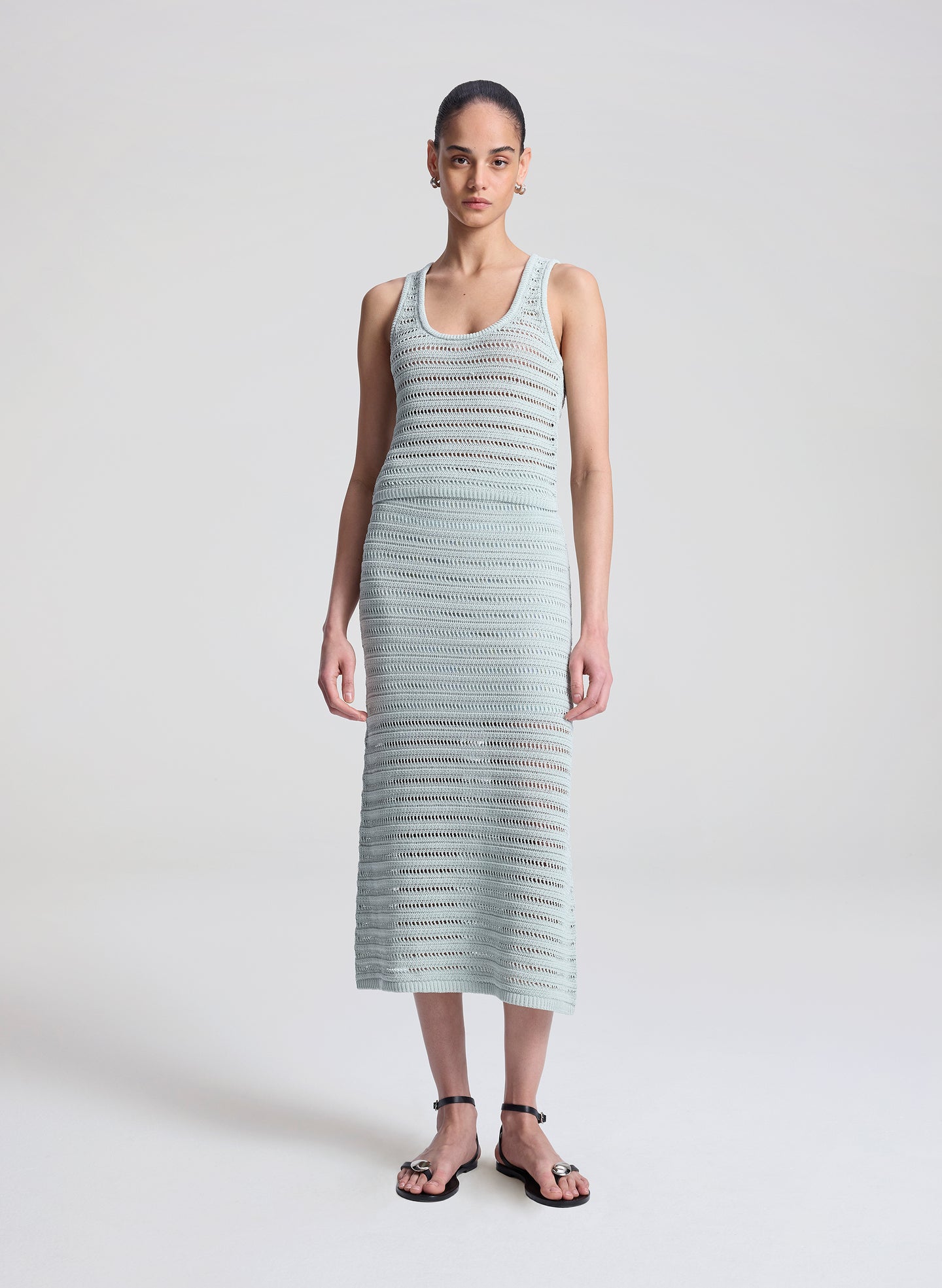 woman wearing light blue crochet tank and skirt set