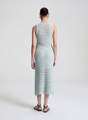 woman wearing light blue crochet tank and skirt set