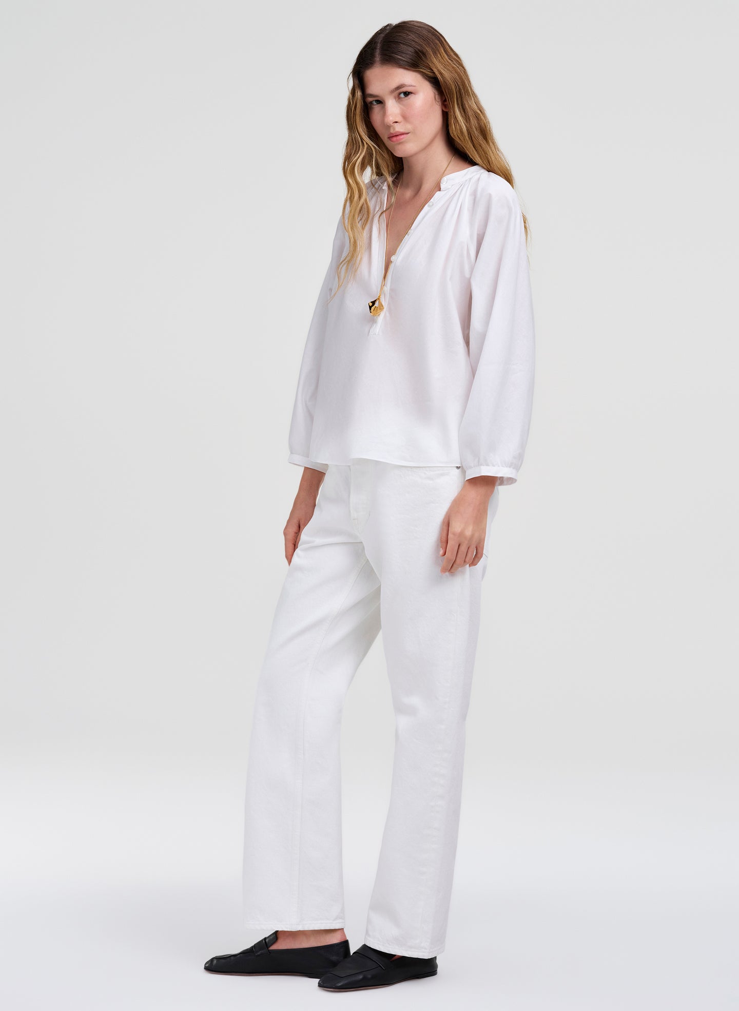 Woman wearing a white outfit with a plain background