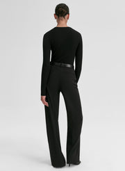 Person wearing a black outfit with a belt on a white background