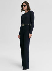 woman wearing a navy blue ribbed sweater and navy blue pants