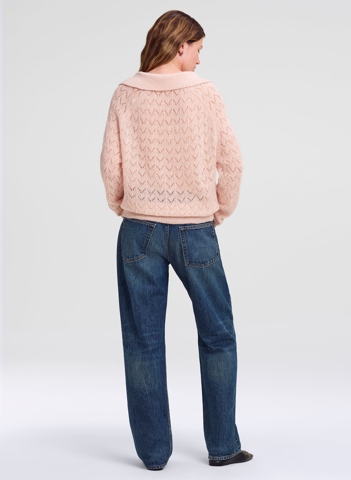 woman in pink sweater and blue jeans