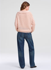 woman in pink sweater and blue jeans