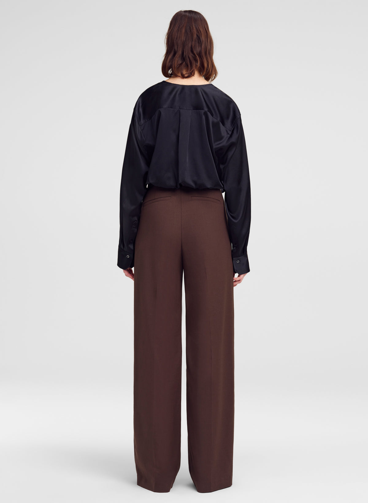 black silk top and brown pants worn by model