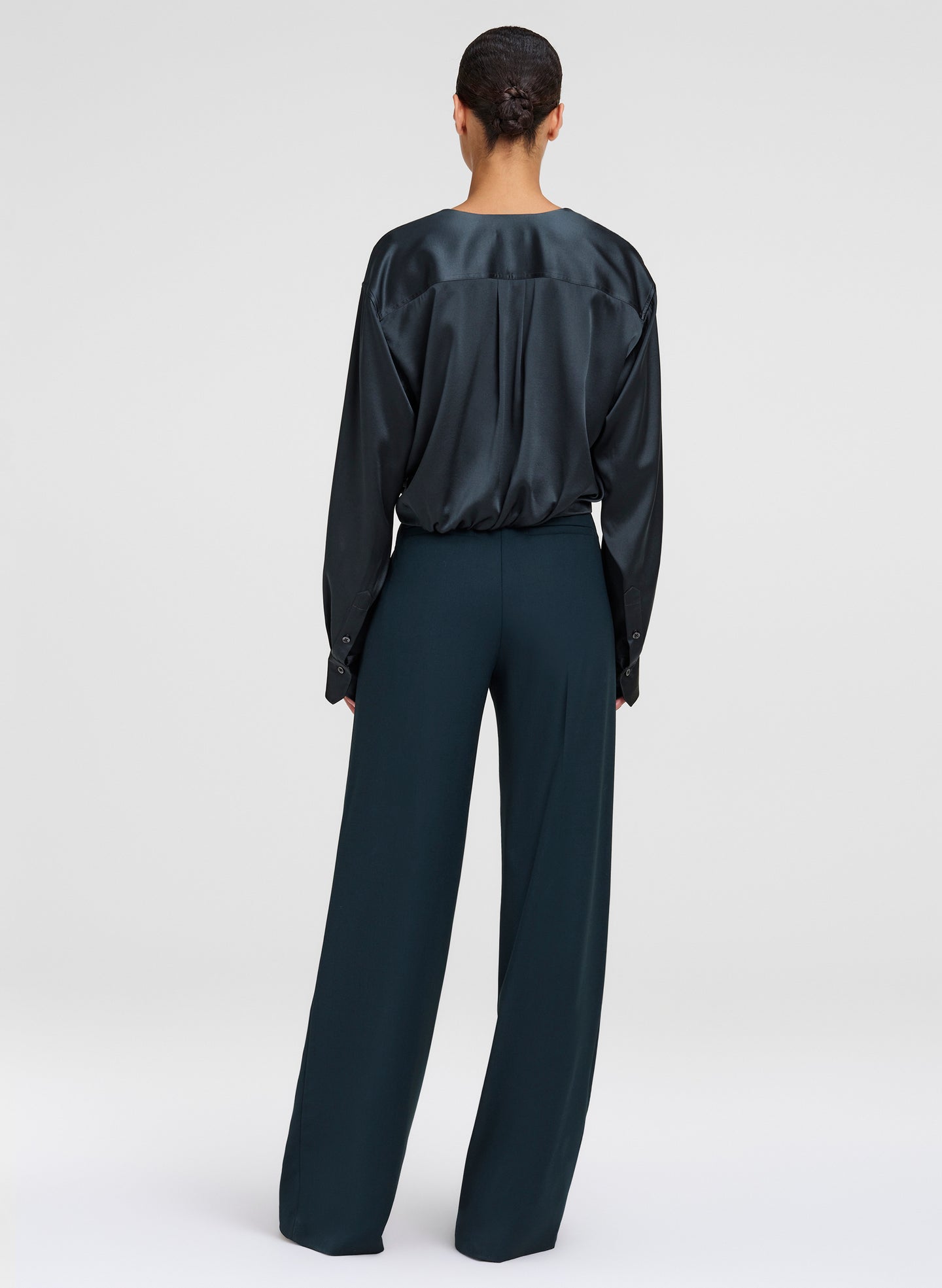woman wearing green long sleeve top and green pants